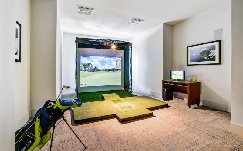 game room with a golf simulator