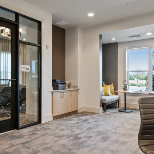 Work Area work area with ample seating, glass enclosed spaces and modern decor